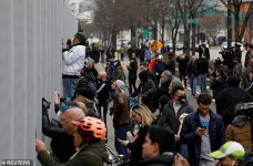 26592962-8167815-People_push_themselves_against_the_railings_to_watch_the_USNS_Co-a-63_158562417.jpg